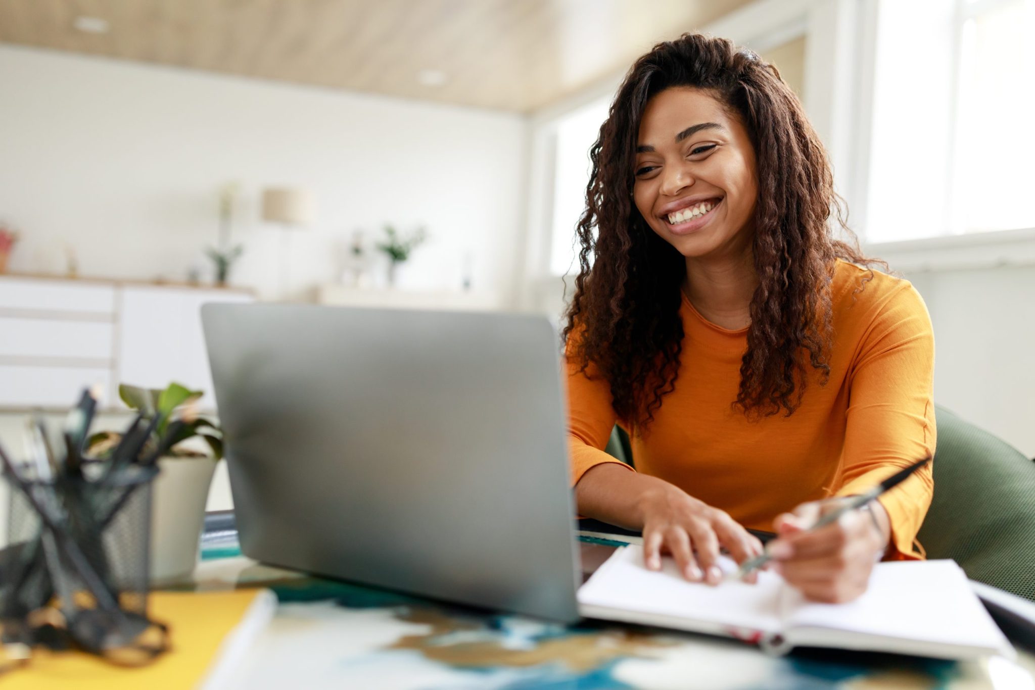 Smiling woman working on laptop